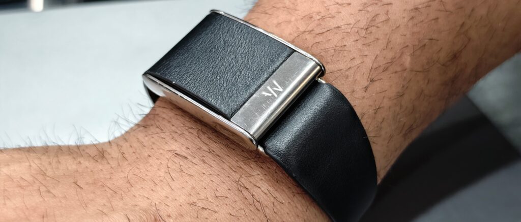 Close-up of a person's wrist wearing a black WHOOP fitness tracker band during activity