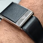 Close-up of a person's wrist wearing a black WHOOP fitness tracker band during activity