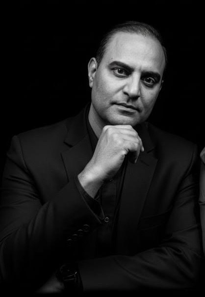 Black and white portrait looking thoughtfully to the side.