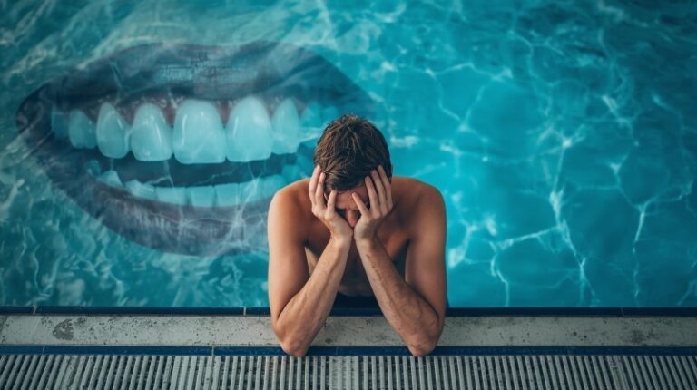 Tired swimmer sitting by the pool with a faint overlay of teeth in the background, showing how poor sleep impacts both oral health and swimming performance.