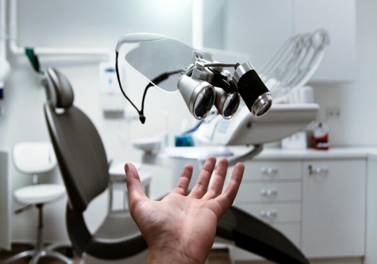 dental clinic scene dentist screening young swimmer gums pre-season, periodontal probe in mouth, healthy pink gums vs red inflamed gums, 70% systemic inflammation text, swimming goggles and trophies in background, shoulder pain prevention